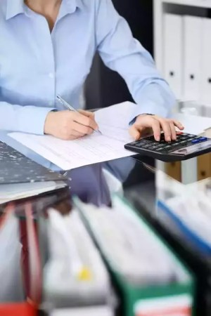 woman analyzing paperwork for an internal audit of a company