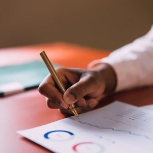 A focused businessperson conducting an audit to ISO 19011:2018.