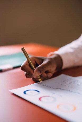 A focused businessperson conducting an audit to ISO 19011:2018.