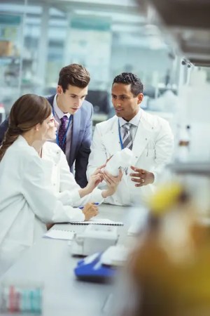 scientists discussing an experiment in a lab.