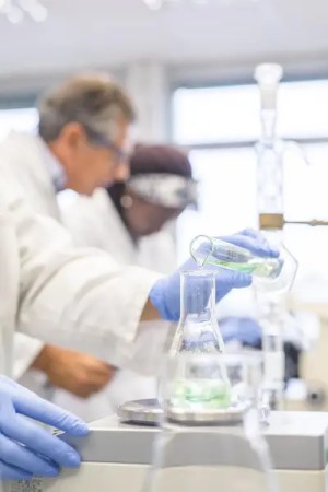 scientist using a scale to measure lab solution