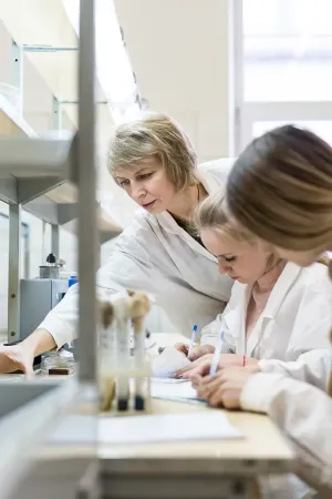 scientists working in a lab taking notes