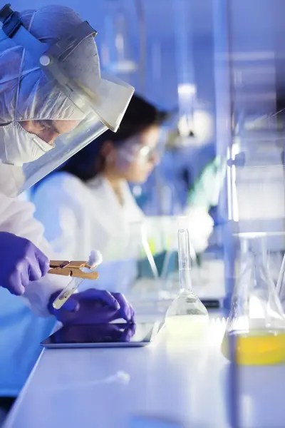 Scientists in a laboratory examining biotech samples for research.