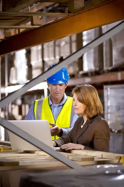 Inspector assessing that warehouse is adhering to ISO/IEC 17020 requirements.