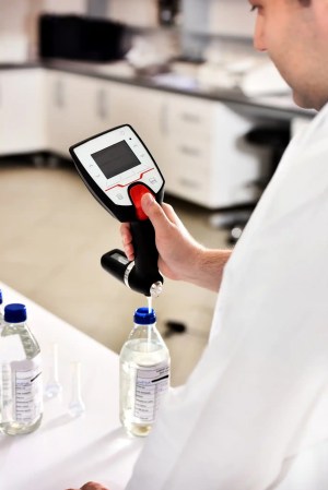 Scientist calibrating lab equipment.