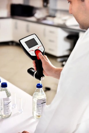 Scientist calibrating lab equipment.