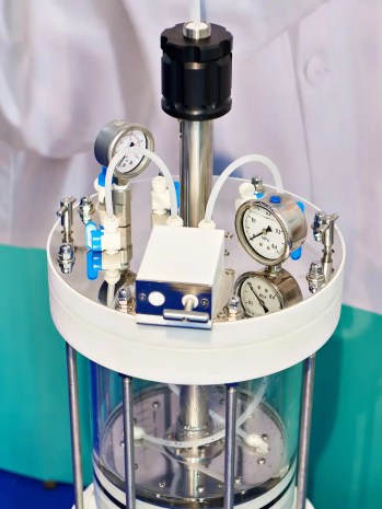 Laboratory chemical reactor with pressure gauges.